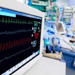 Hospital bedside monitor displaying vital signs in an ICU