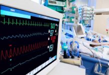 Hospital bedside monitor displaying vital signs in an ICU