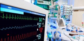 Hospital bedside monitor displaying vital signs in an ICU