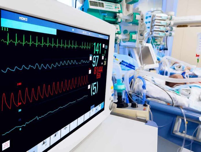 Hospital bedside monitor displaying vital signs in an ICU