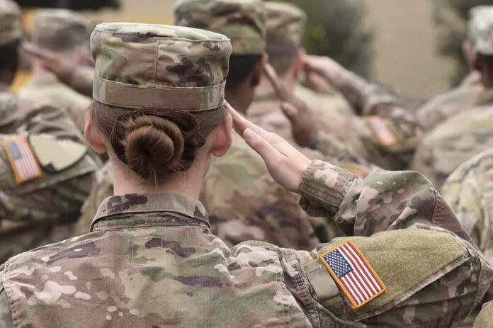 U.S. soldiers in camouflage uniforms saluting