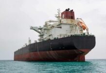 Mines Cleared, Tensions Spike Large oil tanker anchored in calm sea