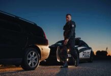 Fingerprint Move Most Drivers Miss Police officer standing near patrol car during twilight traffic stop
