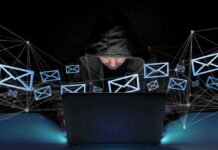 Hooded person using a laptop surrounded by email icons