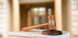 judge's gavel resting on a stack of case files