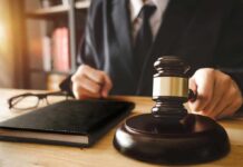 Judge with gavel striking sound block