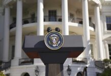 Iran’s Frightening Proposal: Kill Trump for Cash! Presidential podium with seal in front of white-columned building