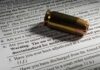 Bullet cartridge on firearm purchase form