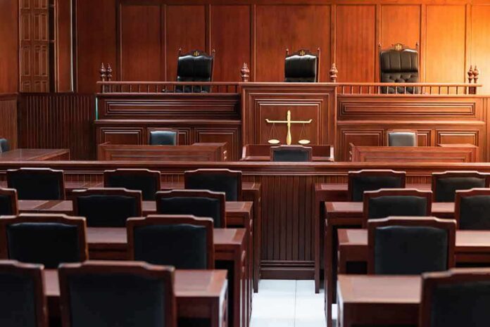 Empty courtroom with wooden benches and judge's bench