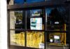 Store entrance with yellow shopping carts behind glass doors