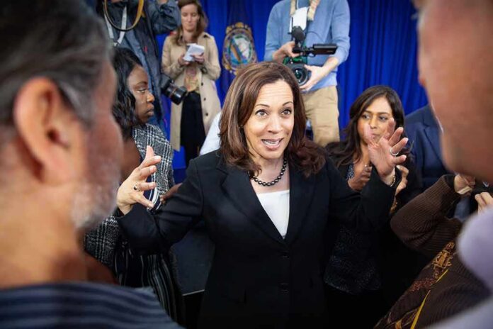 Woman in black blazer speaking animatedly to a crowd