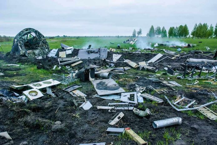Aircraft crash debris scattered across a grassy field