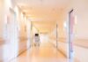 Hospital corridor with doors and medical cart