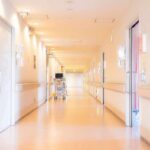 Hospital corridor with doors and medical cart