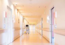 Hospital corridor with doors and medical cart