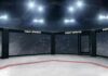 Empty MMA octagon under bright arena lights