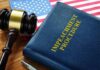 Impeachment procedure book with gavel and U.S. flag