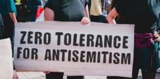 Protester holding a large sign at a rally