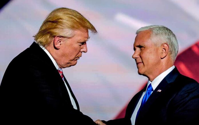 Donald Trump and Mike Pence shake hands on stage