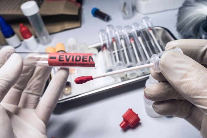 shutterstock_1701288700 Gloved hands handling a swab and evidence tube