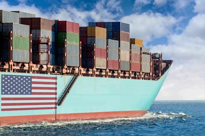 Cargo ship bow loaded with stacked containers at sea