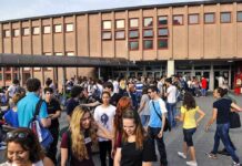 Students gathered outside a school building entrance