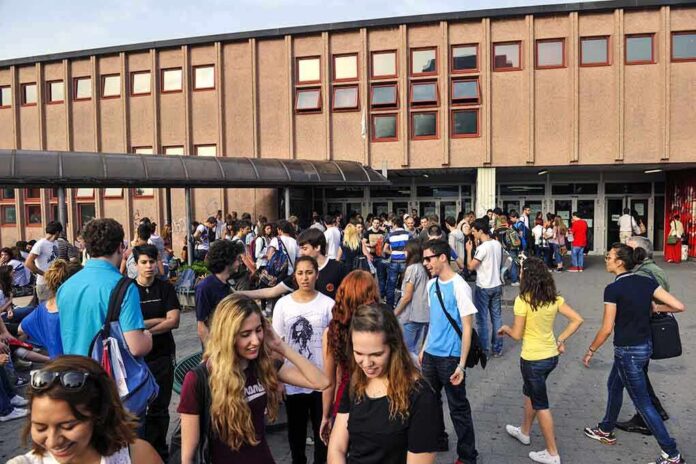 shutterstock_181110272 Students gathered outside a school building entrance