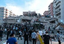 Four Americans Killed In Massive Building Explosion Rescue workers and civilians on collapsed building after earthquake