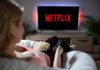 person watching tv with popcorn in a cozy living room
