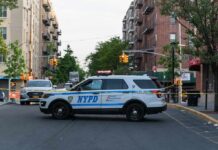 NYPD police SUV blocking a city street at a taped-off scene