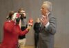 Robert F. Kennedy Jr. speaking to reporters with microphones and a camera