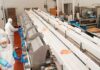 A $250,000 Chicken Heist Ends With 13 Arrests Workers in protective gear at a food processing conveyor line
