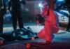 forensic investigator photographs crime scene evidence at night