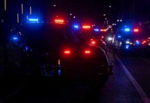 Police vehicles with flashing red and blue lights at night