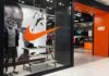 Nike retail store entrance with window display and mannequins