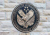 Department of Veterans Affairs seal on brick wall.