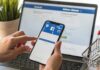 MSI Change Backfires – Anger Goes Viral Hands using a smartphone with a social media login screen