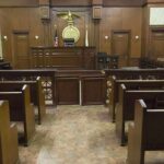 Alarming Testimony Rattles Dolphins Star Interior view of an empty courtroom with wooden benches and a judges bench