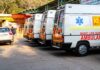 Row of ambulances parked outside a hospital entrance