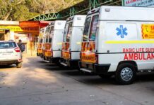 Row of ambulances parked outside a hospital entrance