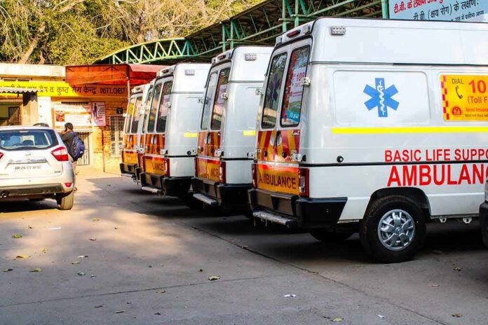 Row of ambulances parked outside a hospital entrance