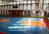 Indoor basketball court with blue floor and orange key areas