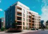 Modern apartment building with balconies in a landscaped courtyard