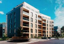 Modern apartment building with balconies in a landscaped courtyard