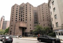 Brutalist high-rise detention facility on a city street