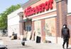 Shock Clampdown: 500 Troops To Milan Office supply store with boarded windows and graffiti