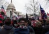 crowd with flags gathered outside the U.S. Capitol building