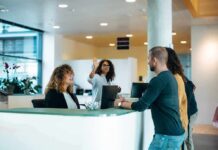 Reception desk with staff assisting visitors