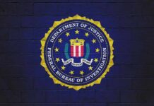 FBI seal painted on a dark brick wall