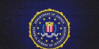 FBI seal painted on a dark brick wall